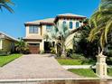 Charming two-story home with a brick driveway and well-manicured landscaping at 18018 Malakai Isle Dr, Tampa, FL 33647