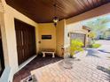Inviting front porch with brick pavers and an ornate light fixture at 18018 Malakai Isle Dr, Tampa, FL 33647