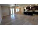 Spacious living room area showcasing hardwood floors, natural light, and an open view to the kitchen at 3269 Ponce De Leon Blvd, North Port, FL 34291