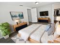 Bright bedroom with a large bed, stylish furnishings, and a walk-in closet for ample storage space at 7604 Tyson Dr, Port Richey, FL 34668