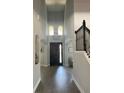 Grand foyer with high ceilings, decorative lighting, wood floors, and an elegant staircase at 302 Coco Plum Ct, Oldsmar, FL 34677
