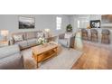 Bright and airy living room featuring neutral decor, comfortable seating, and a cozy rug at 10956 Carlton Fields Dr, Riverview, FL 33579