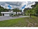 Stately two-story home boasts an attached garage, beautiful landscaping, and a circular driveway at 18620 Wayne Rd, Odessa, FL 33556
