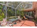Spacious screened-in patio with tile flooring and ample seating for outdoor relaxation at 251 Tropic W Blvd, Largo, FL 33770
