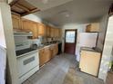 Functional kitchen with wooden cabinets and essential appliances, ready for a remodel at 432 2Nd Ne Ave, Largo, FL 33770