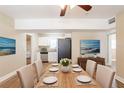 A bright dining room adjacent to the kitchen features wood floors and seating for six at 1020 58Th N Ave, St Petersburg, FL 33703