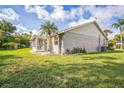 Spacious backyard with lush lawn and enclosed patio with great natural light perfect for relaxing and entertaining at 2015 Gardenia Landings Ln, Sun City Center, FL 33573