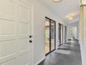 Inviting hallway with sleek tile flooring and courtyard views, creating a bright and airy atmosphere at 2504 Tanglewood Dr, Sarasota, FL 34239