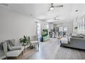 Inviting living room featuring hardwood flooring, an open concept layout, and abundant natural light at 12829 Kings Lake Dr, Gibsonton, FL 33534