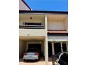Condo exterior showcasing carports, unit entries, and a warm, neutral color palette at 115 1St E St # 103, Tierra Verde, FL 33715