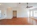 Inviting living room with wood floors, vaulted ceilings, and an abundance of natural light at 11212 3Rd E Ave, Bradenton, FL 34212