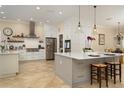 Spacious kitchen with an island, pendant lighting, stainless steel appliances, and white cabinetry at 1751 Bobcat Trl, North Port, FL 34288