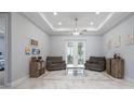 Bright living room with marble floors, recessed lighting, ceiling fan, and patio doors leading to the lanai at 3244 55Th Ave N, St Petersburg, FL 33714