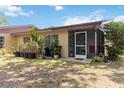 Backyard area with a screened porch, mature plants, and potential for outdoor enjoyment at 4549 Tippecanoe Trl # 20, Sarasota, FL 34233