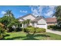 Well-kept single-Gathering home featuring lush greenery, a two-car garage, and a neatly trimmed lawn at 6504 Virginia Xing, University Park, FL 34201
