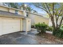 A bright two-story home with a one car garage and manicured landscaping at 11239 Cedar Hollow Ln, Tampa, FL 33618