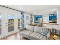 Cozy living room with lake view, open to a kitchen with modern blue cabinets at 265 Seahorse Se Dr # B, St Petersburg, FL 33705