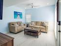 Comfortable living room with neutral sofa, love seat, and marble floors, great for entertaining at 215 Medallion Blvd # G, Madeira Beach, FL 33708
