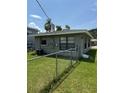 This home includes a backyard with a full fence and green grass at 845 18Th S Ave, St Petersburg, FL 33705