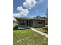 Charming single-story home featuring a covered porch, well-maintained lawn, and neat landscaping at 845 18Th S Ave, St Petersburg, FL 33705