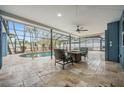 Enclosed outdoor swimming pool with travertine tile and surrounded by comfortable seating, perfect for relaxing at 5108 Saint Albans Ave, Siesta Key, FL 34242