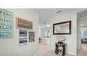 Inviting foyer with tile flooring, coastal decor, and open view to dining and kitchen areas at 135 Florida Blvd, Crystal Beach, FL 34681