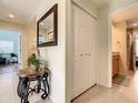 Hallway with tile flooring, closet space, and access to a bathroom at 135 Florida Blvd, Crystal Beach, FL 34681