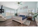 Bright main bedroom with a vaulted ceiling, wood floors, and ensuite bath at 135 Florida Blvd, Crystal Beach, FL 34681
