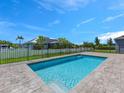 Beautiful backyard swimming pool is surrounded by a fence and a brick deck at 9257 King Hill St, Port Charlotte, FL 33981