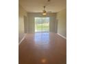 Bright and airy living room featuring a sliding glass door leading to the outdoors at 1452 Crazy Horse Dr, Lutz, FL 33559