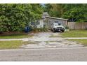 Charming single-story home with a small yard and parked vehicles in the driveway at 15272 Avalon Ave, Clearwater, FL 33760