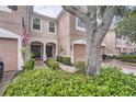 Two-story townhome with a one-car garage and landscaped front yard and entryway at 26622 Castleview Way, Wesley Chapel, FL 33544
