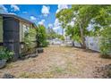 This is a fenced-in backyard with space and a nice tree at 1711 E Sewaha St, Tampa, FL 33612