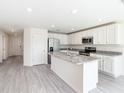 Bright kitchen featuring white cabinets, stainless steel appliances, and granite countertops at 23461 Wickens Ave, Port Charlotte, FL 33980