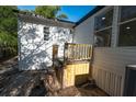 Exterior side view of home with stairs leading up to the side entrance and window at 5907 Sussex Ct, Tampa, FL 33615