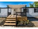 Welcoming front porch with wooden deck, black railings, and covered roof at 5907 Sussex Ct, Tampa, FL 33615