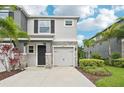 Two-story home featuring a stone-accented facade, attached garage, and well-maintained landscaping at 8661 Daydream St, Sarasota, FL 34238