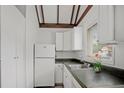 Functional kitchen space with white cabinets, sleek countertops, and a sunny window at 5641 Ashley Oaks Dr # 39, Tampa, FL 33617