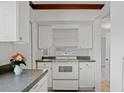 Kitchen featuring white cabinets, countertops, and appliances at 5641 Ashley Oaks Dr # 39, Tampa, FL 33617