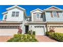 Charming townhome exterior features colorful siding, two-car garage, and well-maintained landscaping at 6204 Camino Dr, Apollo Beach, FL 33572