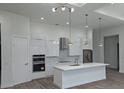 Modern kitchen features stainless appliances, a marble backsplash, an island and modern pendant lighting at 14914 San Domingo Blvd, Port Charlotte, FL 33981