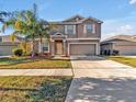Attractive two-story home with neat landscaping, driveway, and a well-manicured lawn at 8506 Hunters Fork Loop, Ruskin, FL 33573
