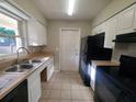 A functional kitchen with essential appliances and ample cabinet space for storage at 3217 Deerfield Dr, Tampa, FL 33619