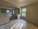 A spacious living room area with neutral paint, tiled floors and natural light at 3217 Deerfield Dr, Tampa, FL 33619