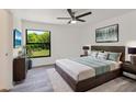 Comfortable bedroom featuring a large window, neutral decor, and ample natural light at 19543 Midway Blvd, Port Charlotte, FL 33948