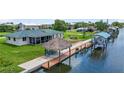 Waterfront home featuring a screened lanai, tiki hut and boat lift at 24277 Treasure Island Blvd, Punta Gorda, FL 33955