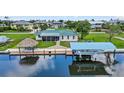 Waterfront home featuring screened in porch, dock with tiki hut and a covered boat lift at 24277 Treasure Island Blvd, Punta Gorda, FL 33955