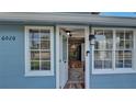 View from the front door into the house featuring hardwood floors, and modern lighting at 6020 Illinois Ave, New Port Richey, FL 34653