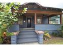 Charming front porch with blue wood paneling, ceiling fans, and a welcoming entrance at 834 Jackson N St, St Petersburg, FL 33705