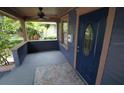 Inviting front porch with a decorative door, ceiling fan, and space for seating at 834 Jackson N St, St Petersburg, FL 33705